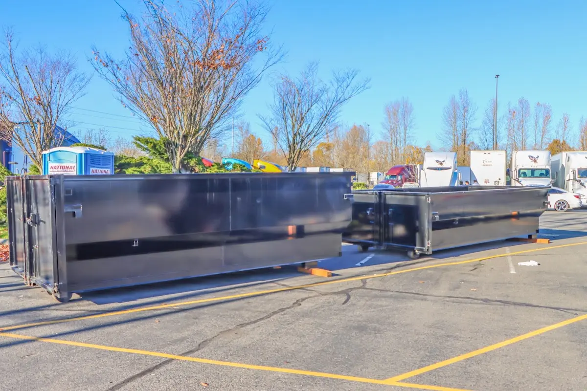 Professional dumpster rental service with roll-off container on residential driveway in Rockwood